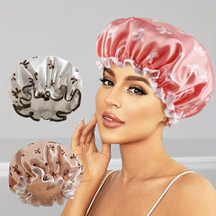 Woman wearing a pink satin shower cap with three additional shower caps displayed below on a gray background.